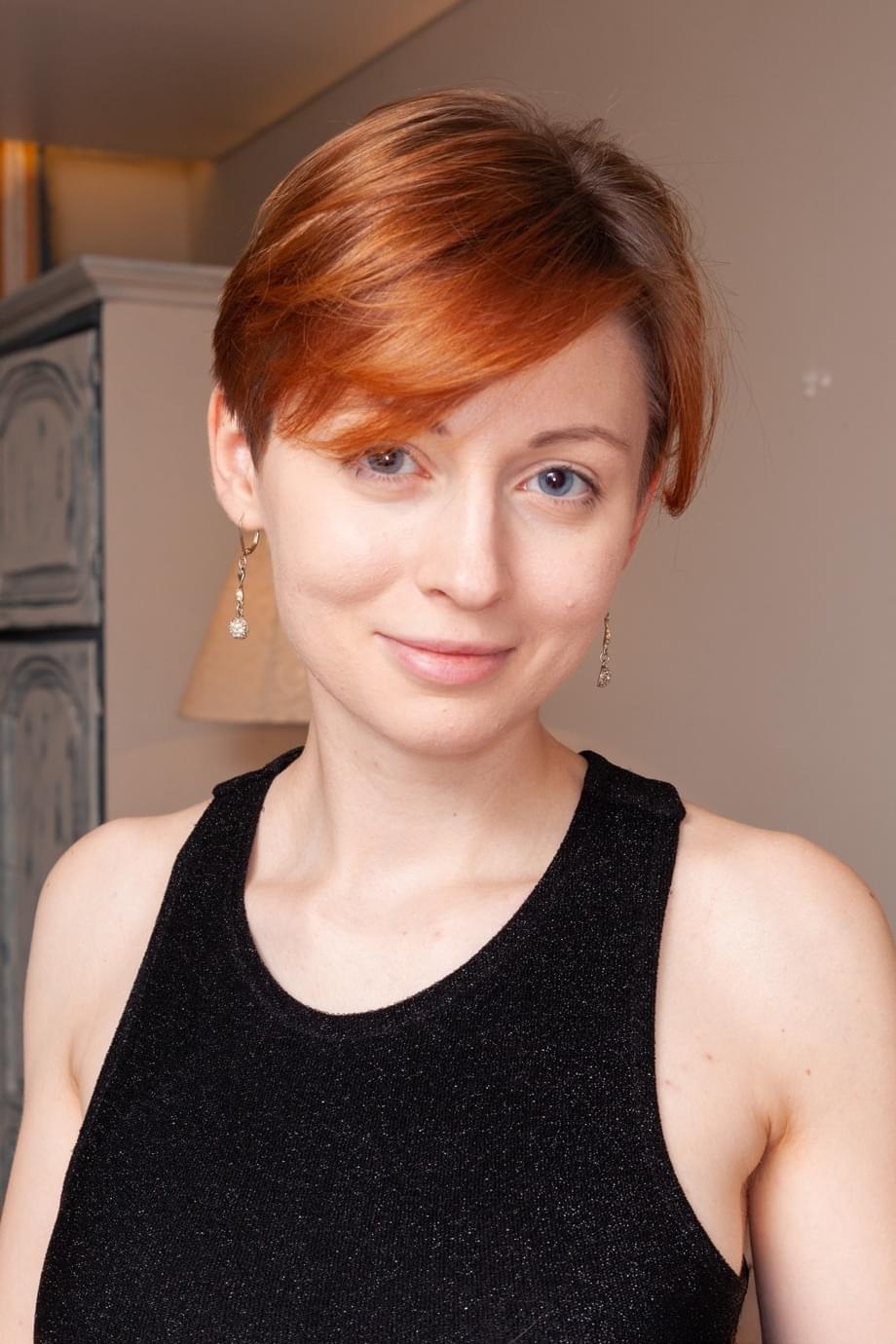 Short haired redhead fingers her bush after baring her firm tits