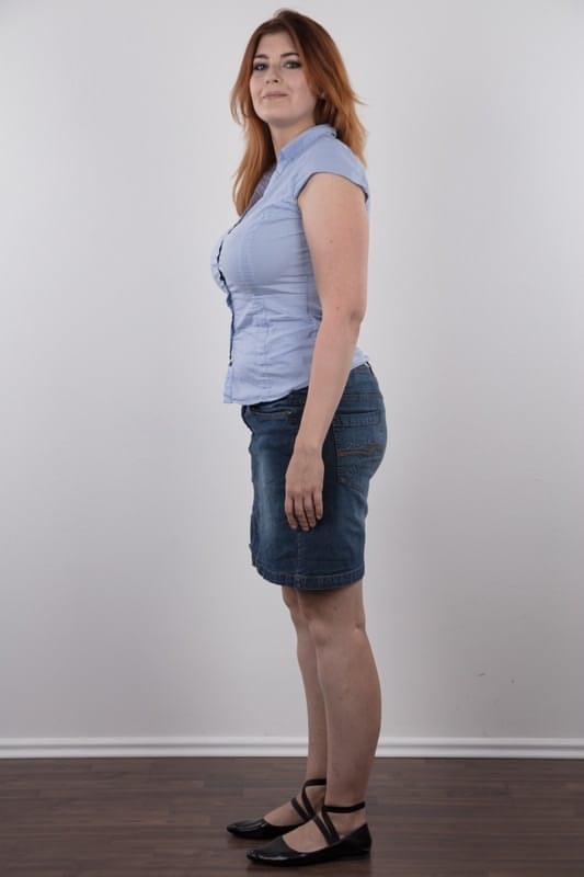 Overweight redhead Eva stands straight while clothed and totally naked too