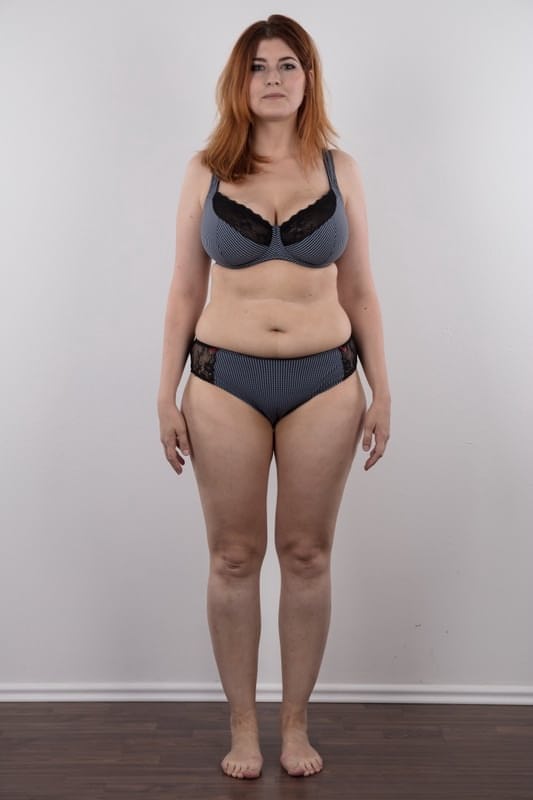 Overweight redhead Eva stands straight while clothed and totally naked too