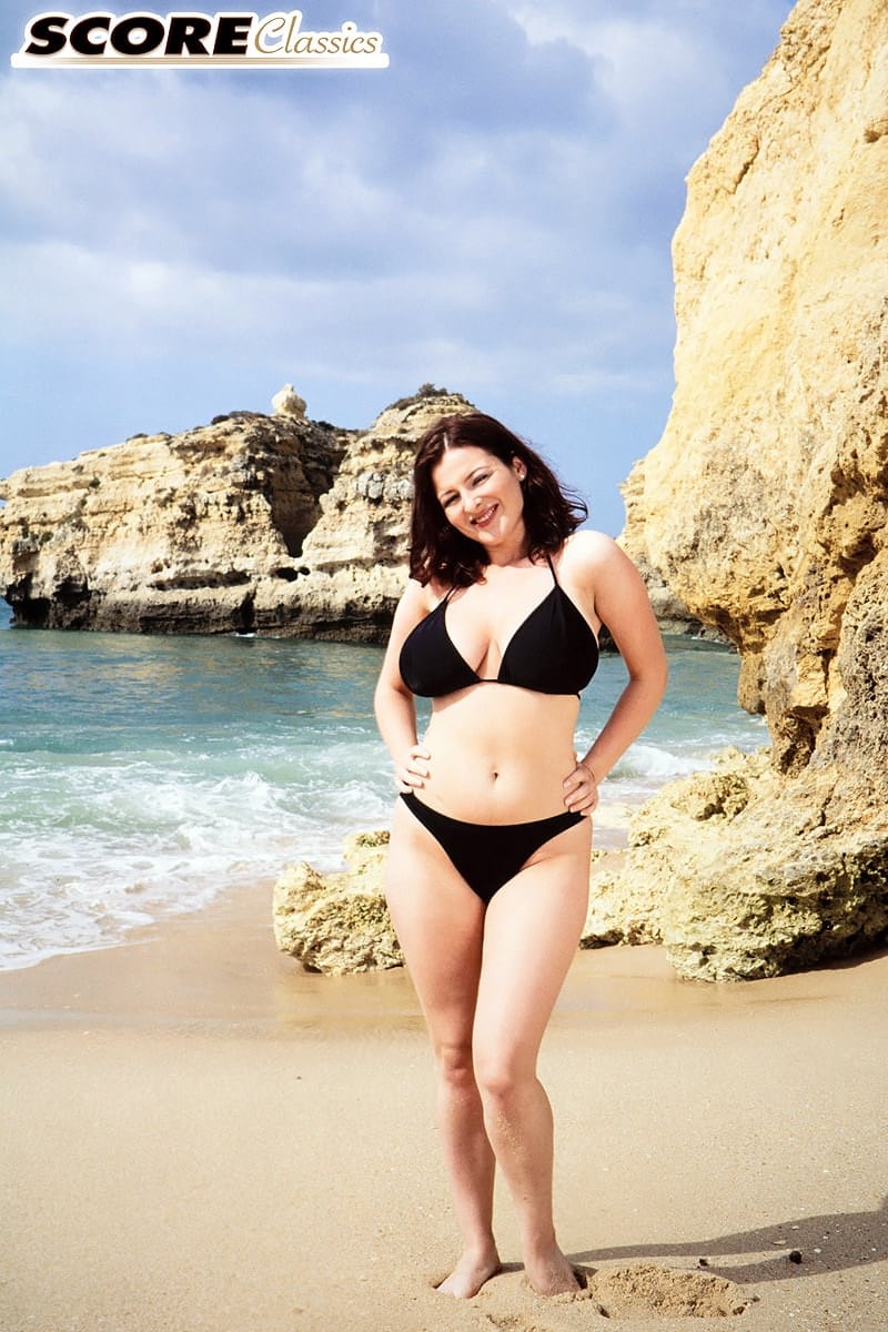 Brunette MILF Lorna Morgan releases her nice melons from bikini on a beach