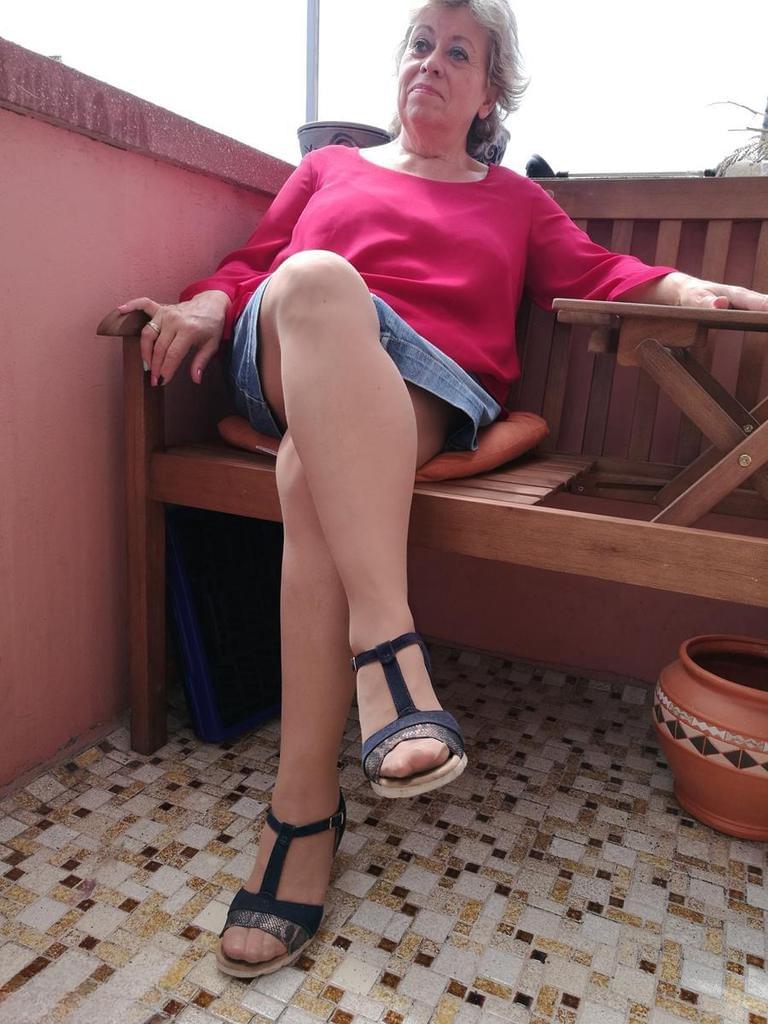 Horny oma spreads her upskirt pussy after pulling down her hose on patio