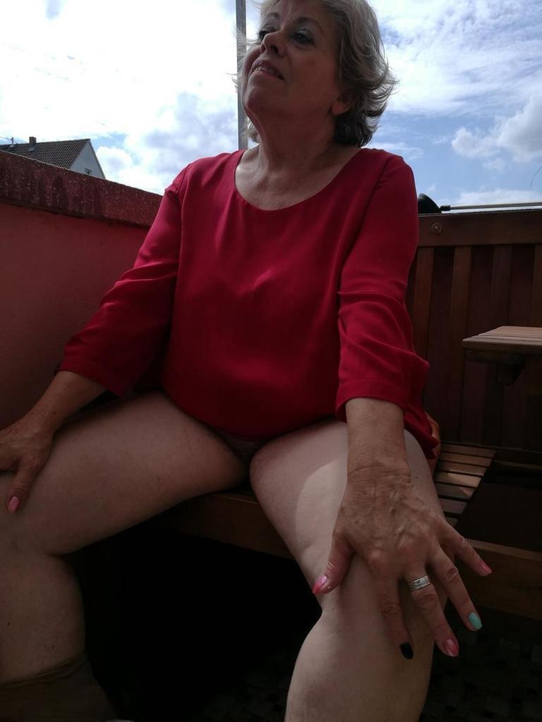 Horny oma spreads her upskirt pussy after pulling down her hose on patio