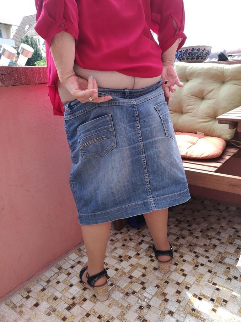 Horny oma spreads her upskirt pussy after pulling down her hose on patio