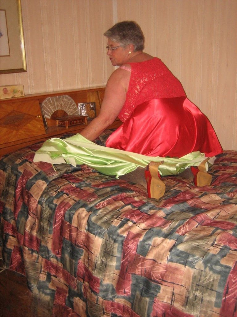 Fat granny Girdle Goddess pets her pussy after stripping to hosiery on her bed