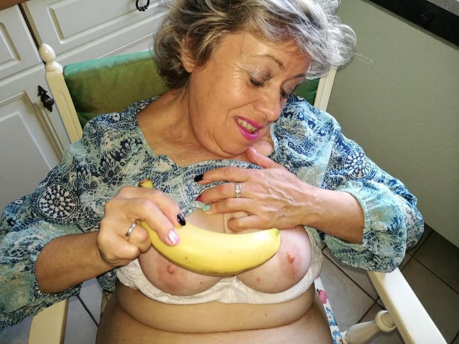 Horny granny Caro sticks a banana inside her natural pussy on kitchen chair