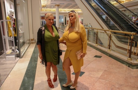 Fully clothed housewives with blonde hair share a first lesbian kiss