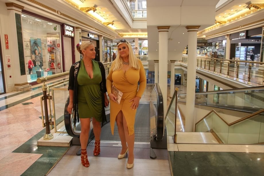 Fully clothed housewives with blonde hair share a first lesbian kiss