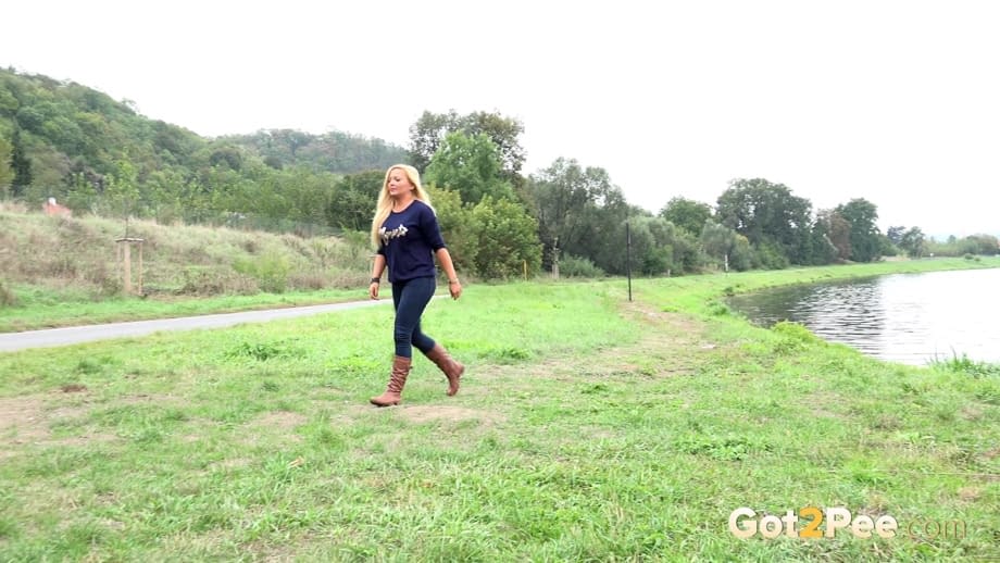 Thick blond chick Jenna Lovely squats for a piss next to bench beside the road