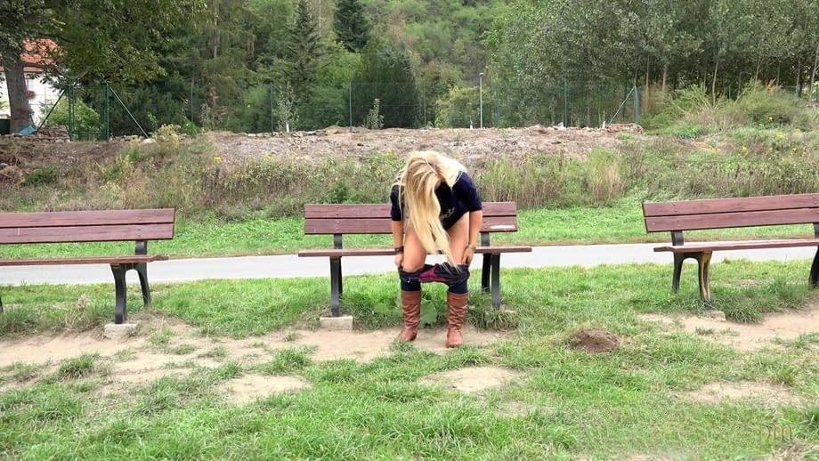 Thick blond chick Jenna Lovely squats for a piss next to bench beside the road
