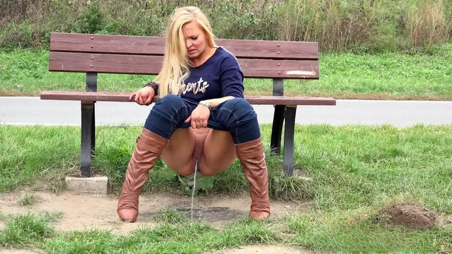 Thick blond chick Jenna Lovely squats for a piss next to bench beside the road