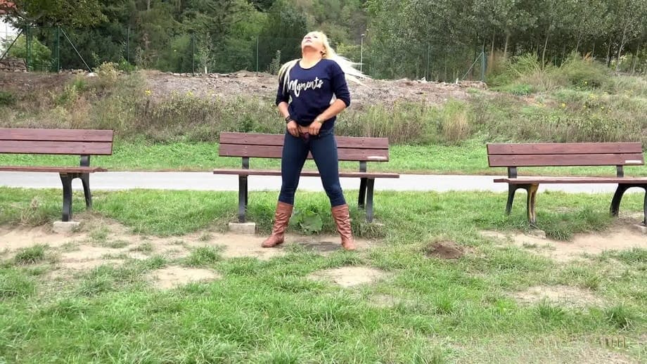 Thick blond chick Jenna Lovely squats for a piss next to bench beside the road