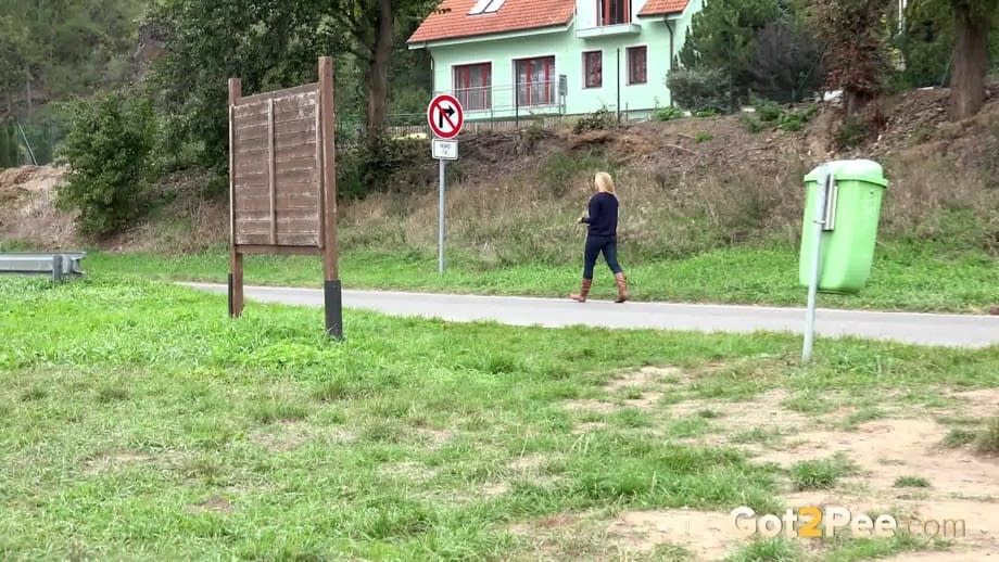 Thick blond chick Jenna Lovely squats for a piss next to bench beside the road