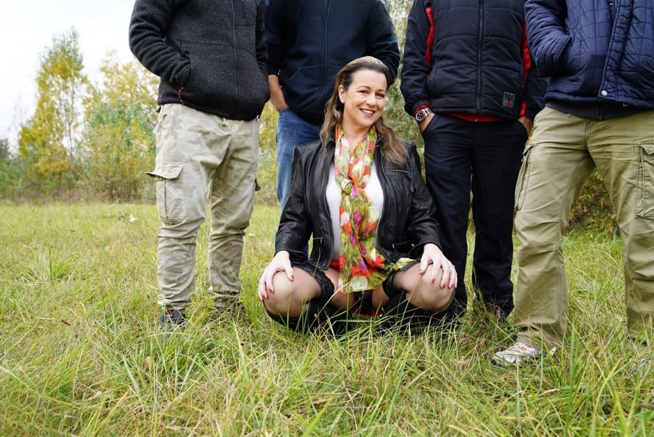 Horny granny Eva Jayne gets cum on her face after a gangbang in a field