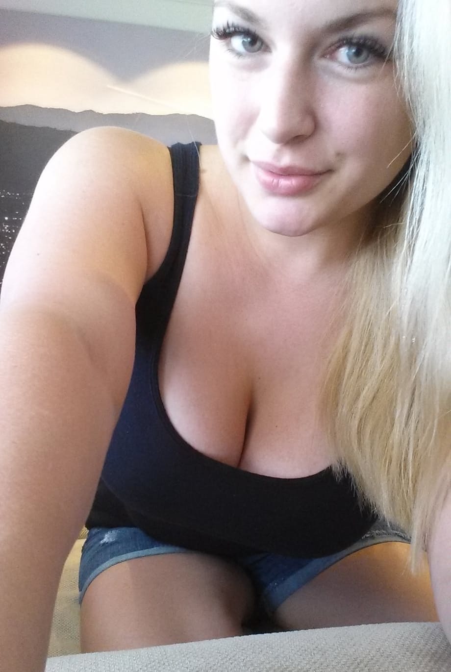 Blonde amateur with natural tits pulls out her phone for naked selfies