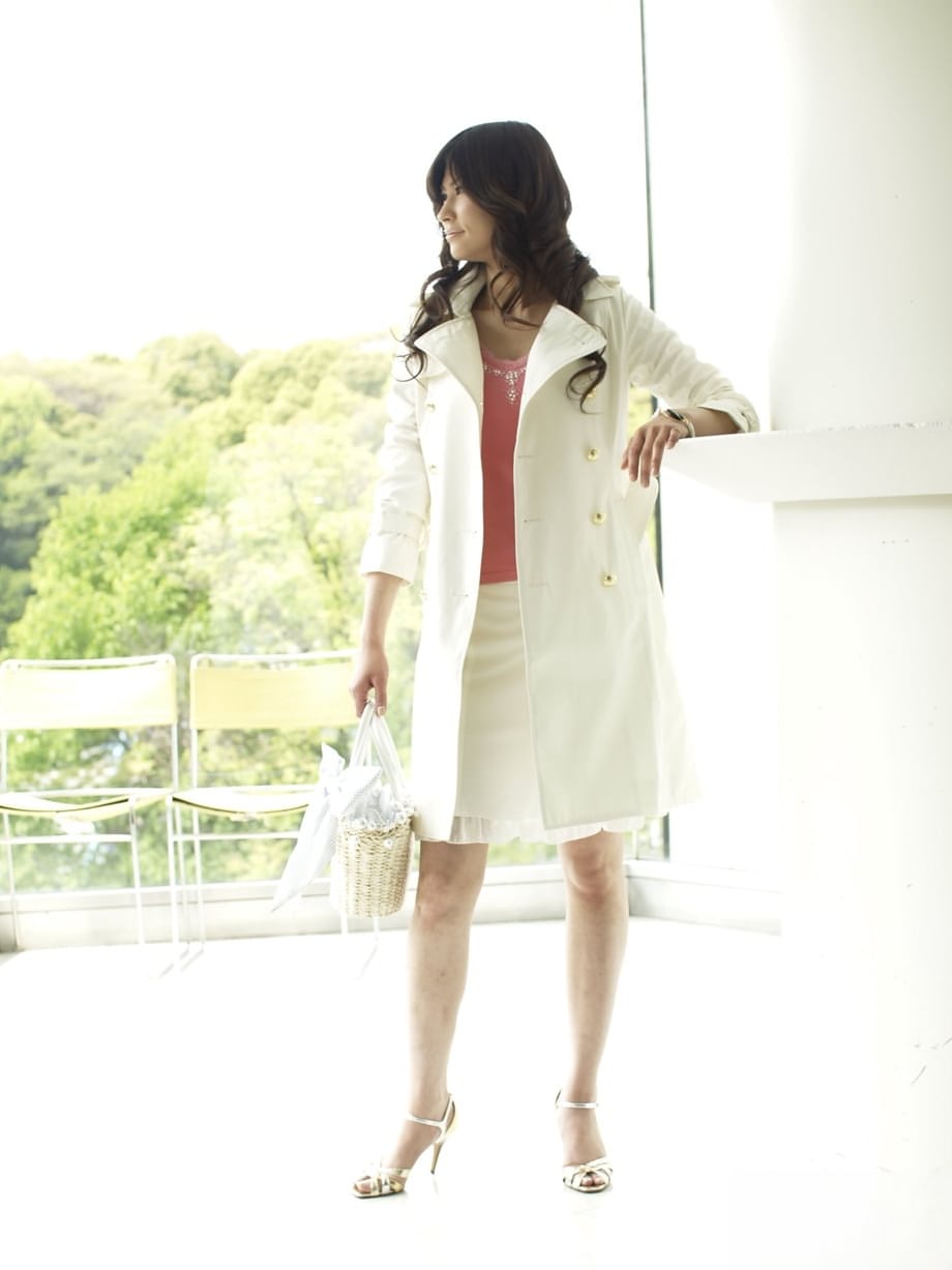 Clothed Japanese model Yuka Yamada shows her bare legs in a skirt