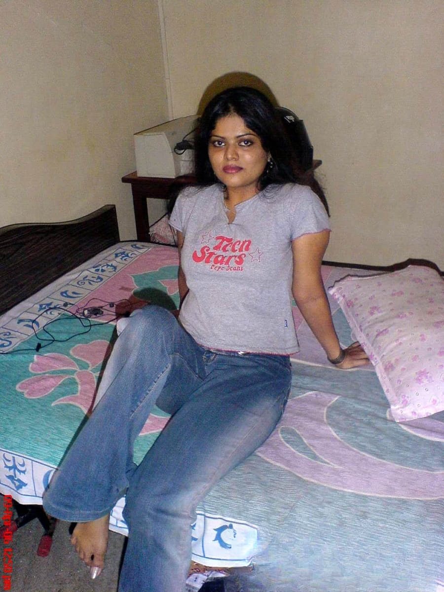 Petite Indian girl uncups big naturals after removing blue jeans