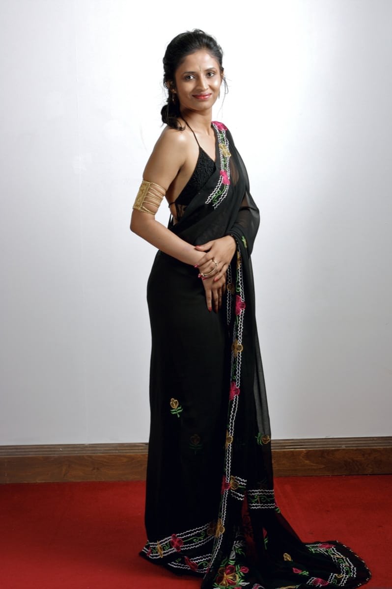 Slender Indian woman removes her sari to model in black lingerie