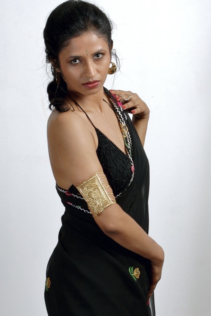 Slender Indian woman removes her sari to model in black lingerie