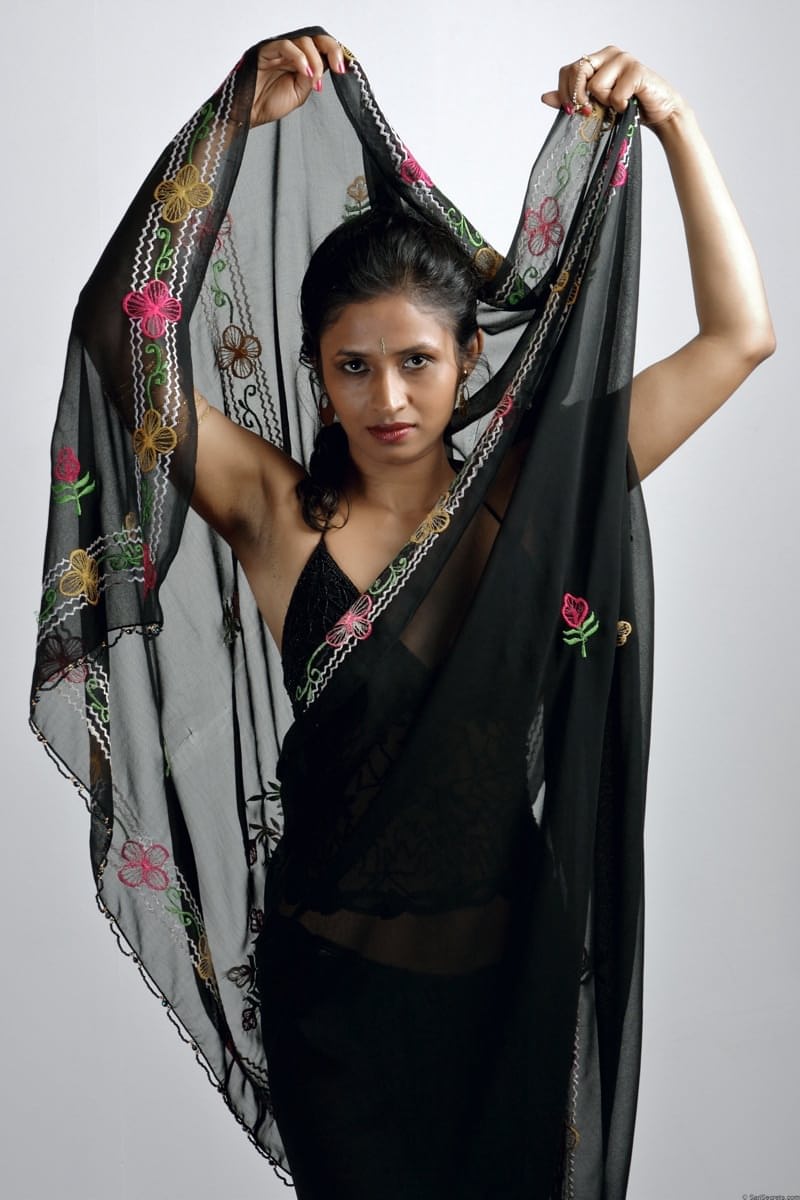 Slender Indian woman removes her sari to model in black lingerie