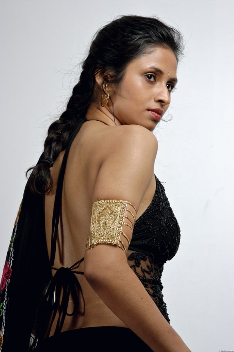 Slender Indian woman removes her sari to model in black lingerie