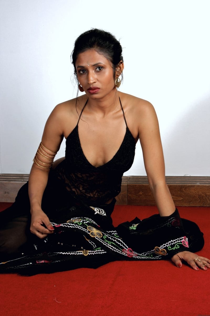 Slender Indian woman removes her sari to model in black lingerie