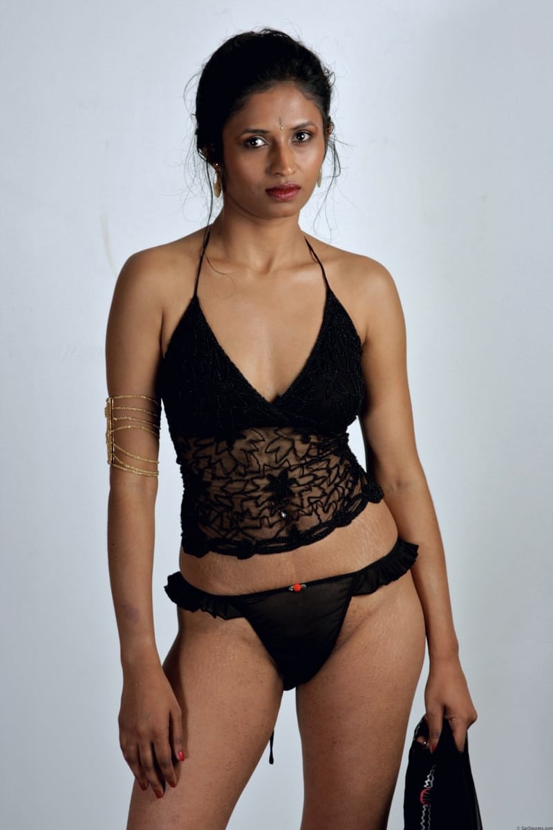 Slender Indian woman removes her sari to model in black lingerie