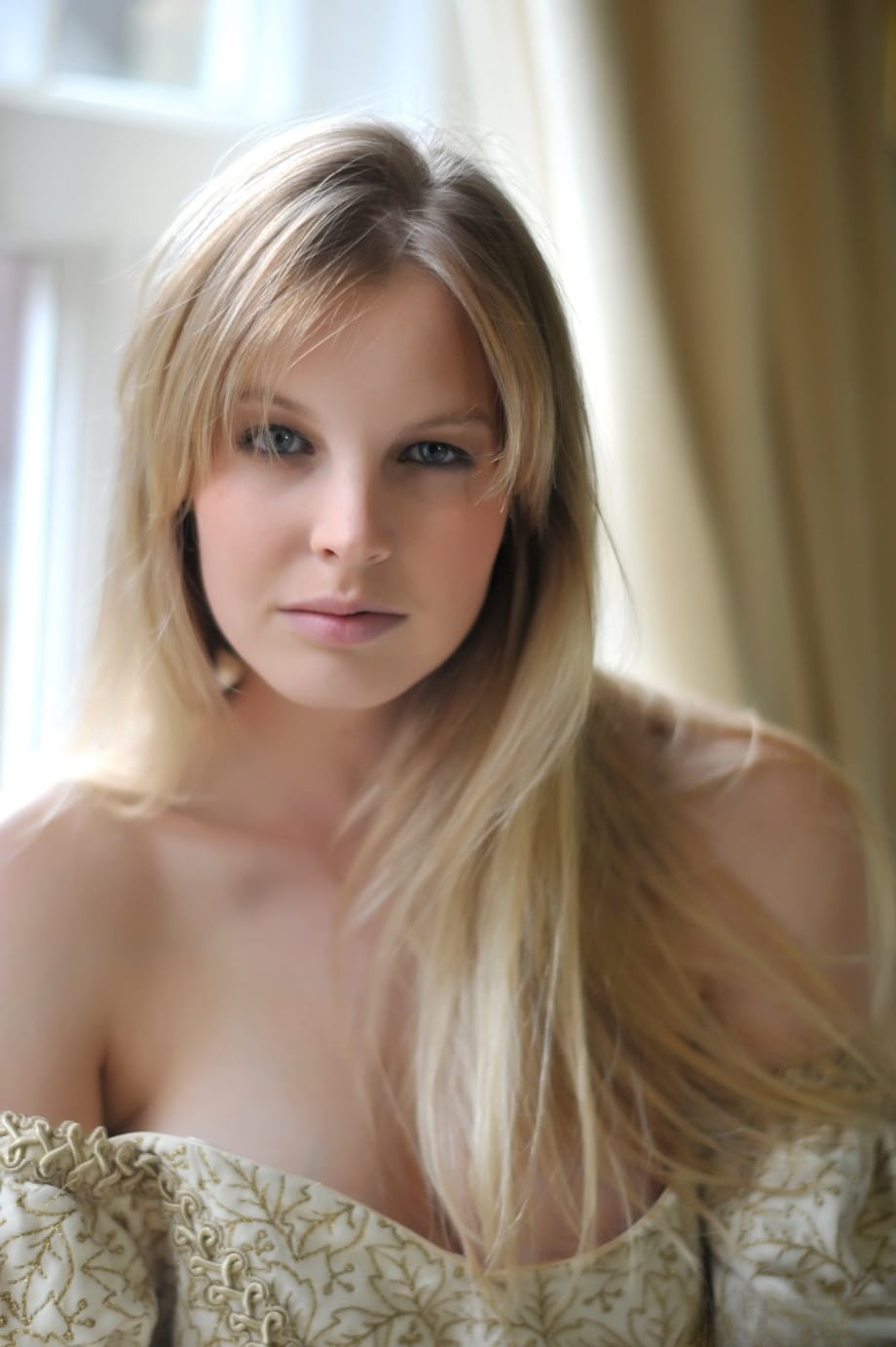 Blonde girl Rose takes off her petticoat to model in a girdle and nylons