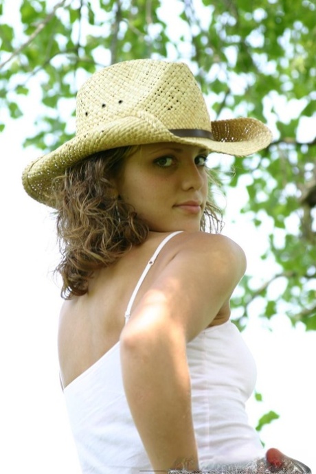 Teen amateur Karen lets denim skirt ride up to expose her underwear in yard