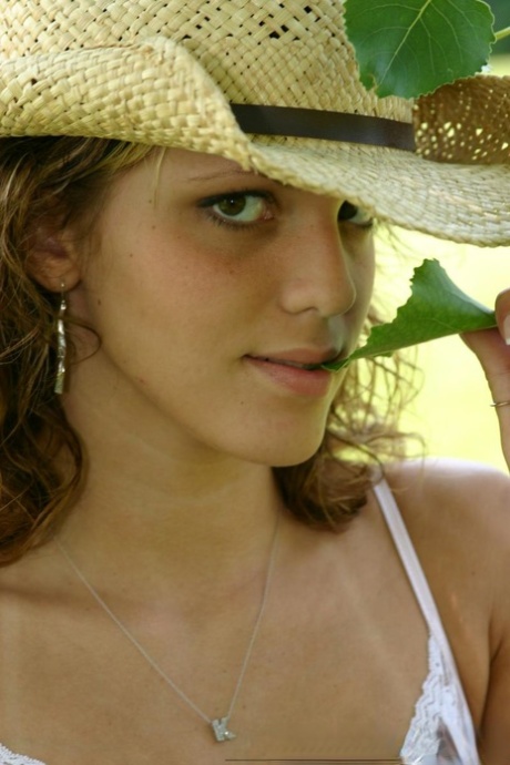 Teen amateur Karen lets denim skirt ride up to expose her underwear in yard