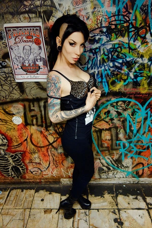 Goth girl Razor Candi strips to OTK boots in graffiti filled bathroom
