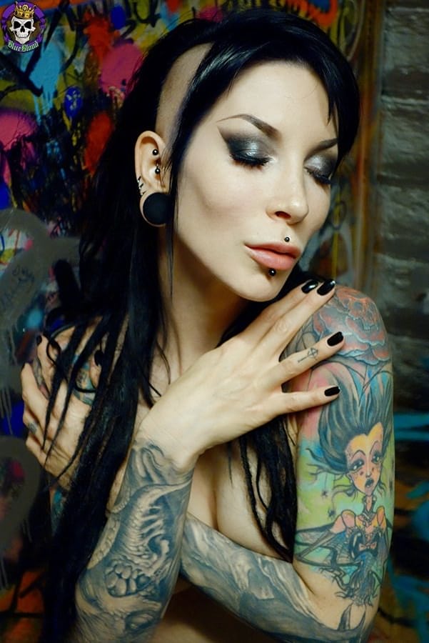 Goth girl Razor Candi strips to OTK boots in graffiti filled bathroom