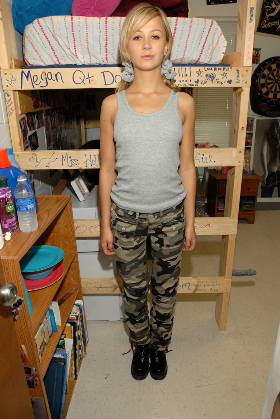 Blonde teen pulls down camo pants before having her tight ass flogged