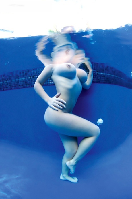 Busty model Lana Ivans removes her bikini before plunging into swimming pool