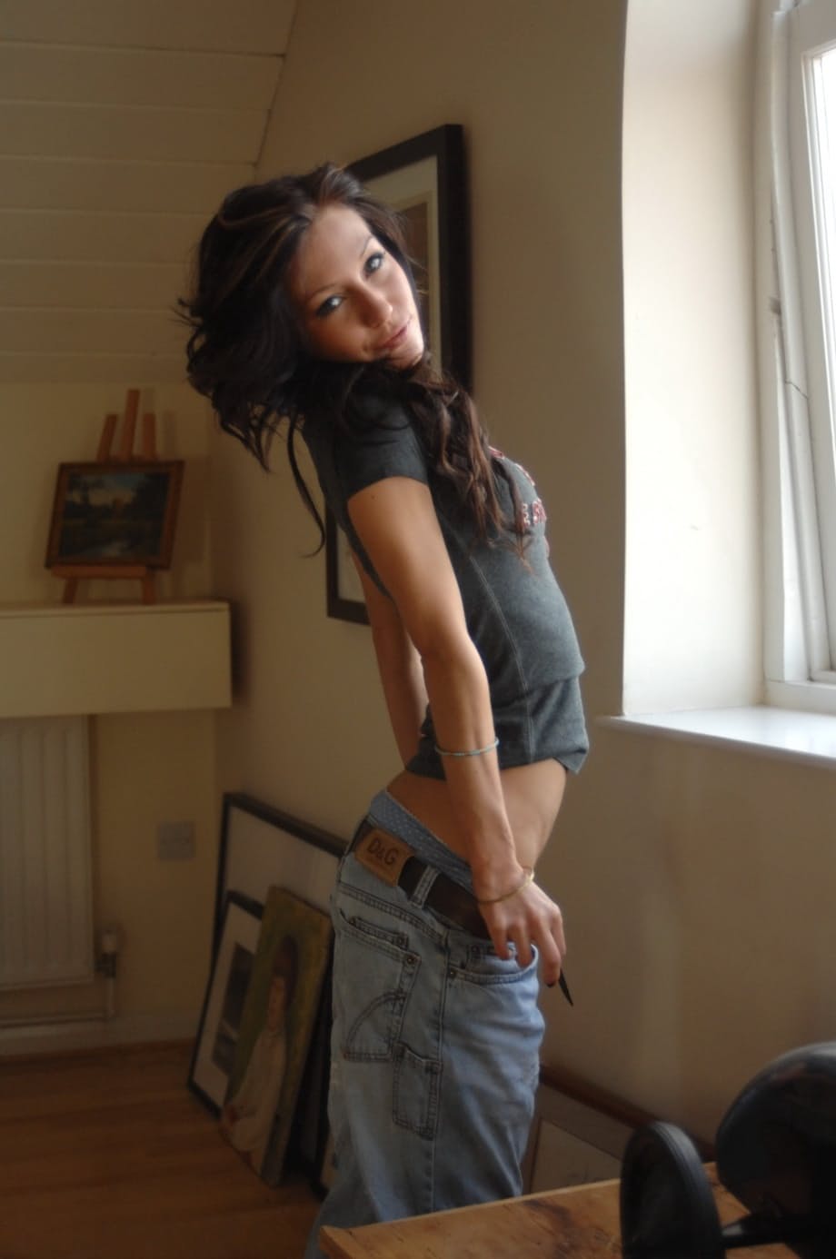 Brunette solo girl Rosie covers her private parts after getting totally naked