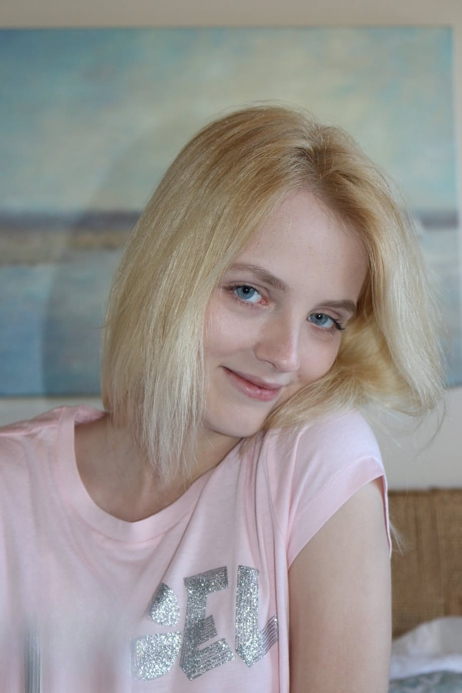 Petite blonde Kate Bloom parts her wet pussy after getting naked on her bed