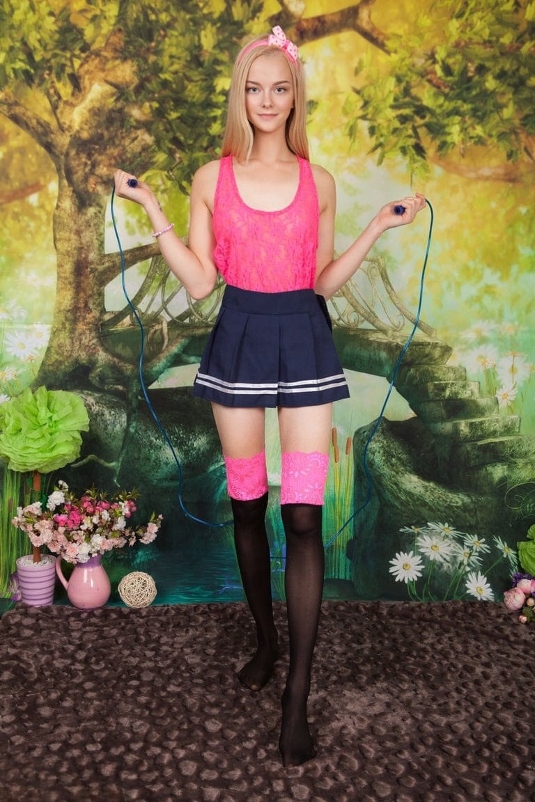 Young looking blonde Natasha showcases her pussy once she's totally naked