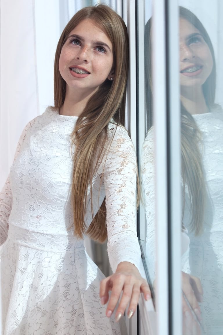 Young looking girl Rina takes off her pretty dress to model totally naked