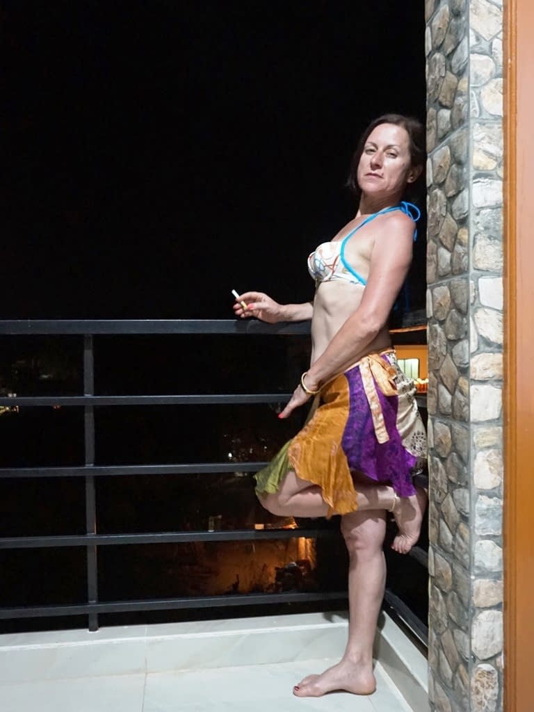 Mature woman Diana Ananta smokes a cigarette while exposing her snatch