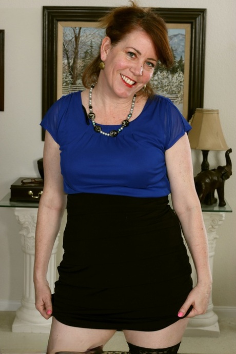 Middle-aged woman Caitlin Moore disrobes to shows her snatch in stockings