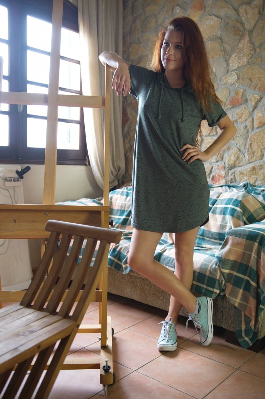 Natural redhead Mia Sollis stands totally naked after disrobing at home