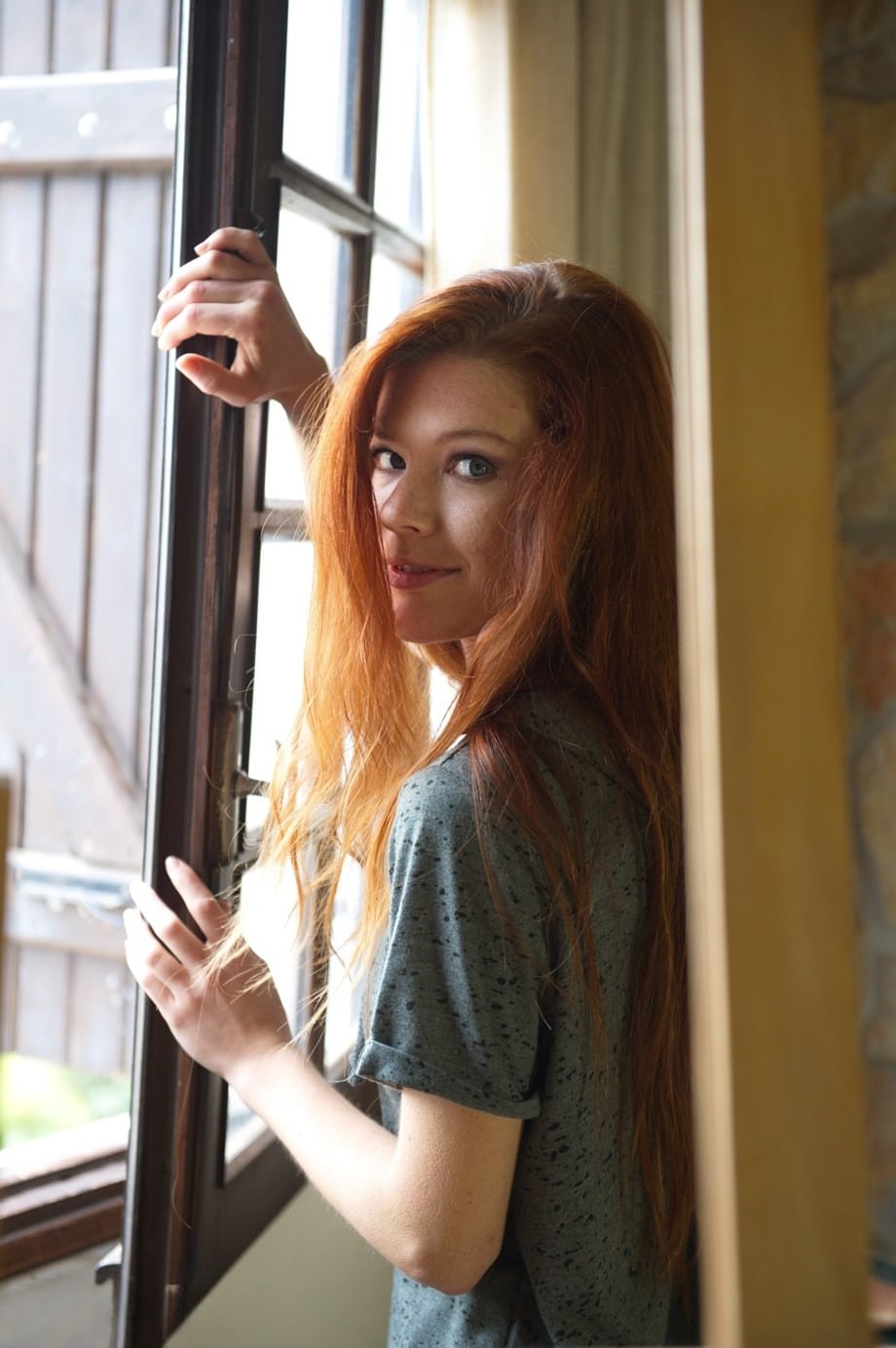 Natural redhead Mia Sollis stands totally naked after disrobing at home