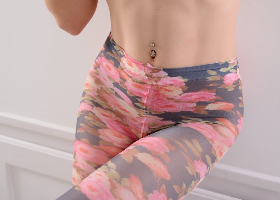Caucasian girl slips leggings over butt plug adorned ass in black pumps