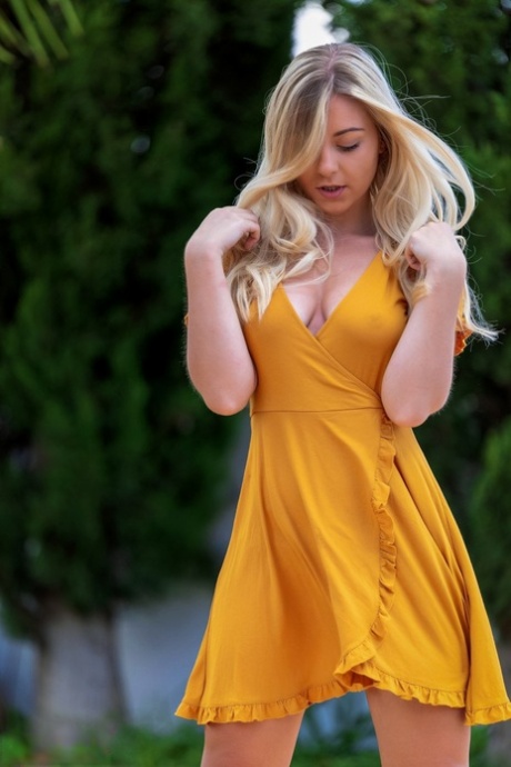 Blonde amateur Elle Hunter shows some leg before modelling naked on walkway
