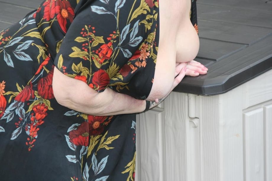 Naughty granny shows her tits and twat in backyard wearing red stockings
