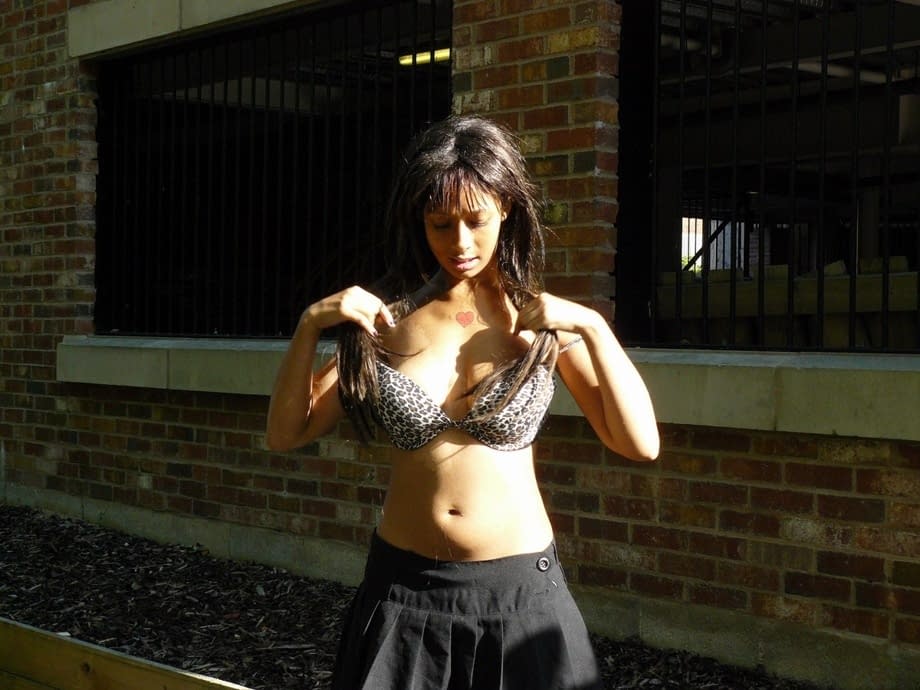 Ebony chick fingers her pussy on roadway while a jogger passes by