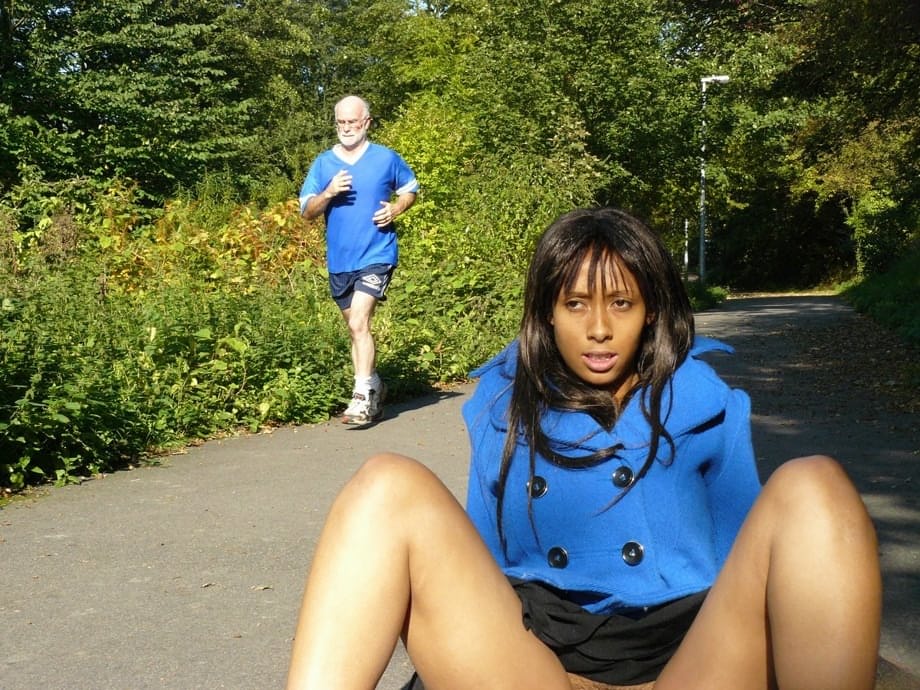 Ebony chick fingers her pussy on roadway while a jogger passes by