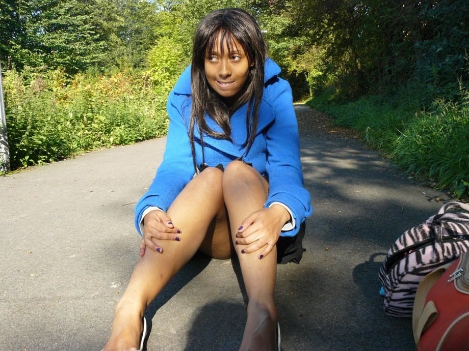 Ebony chick fingers her pussy on roadway while a jogger passes by