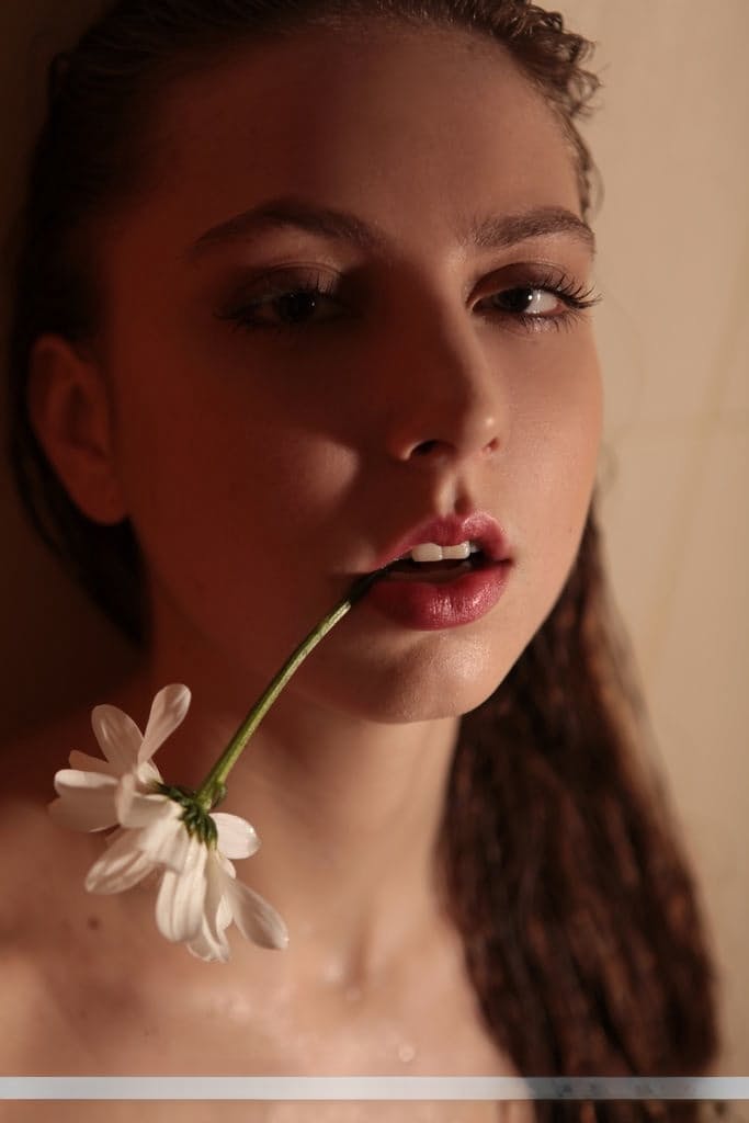 Sultry teen Valery Leche gets into a petal filled tub after removing lingerie