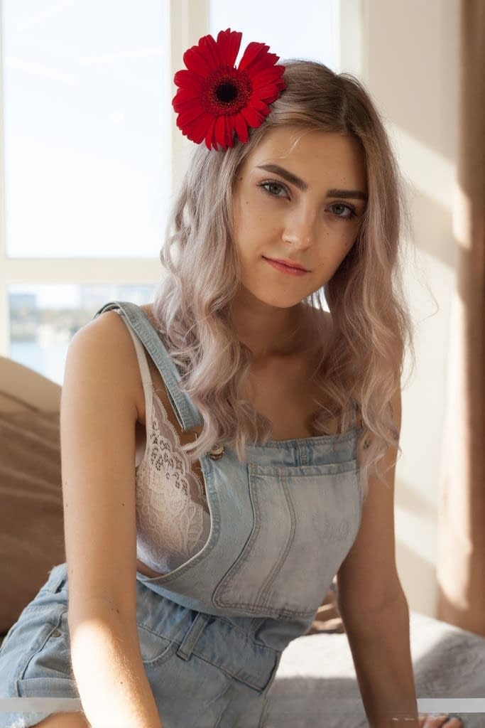 Young blonde Eva Elfie shows off her great body with a flower in her hair