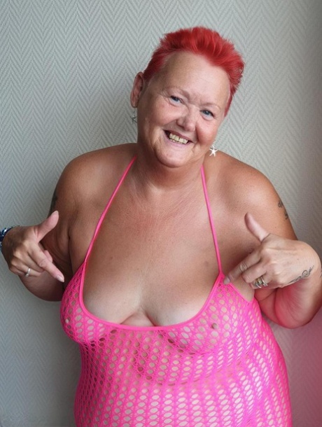 Fat nan with short red hair finger spreads her pussy on oceanside balcony